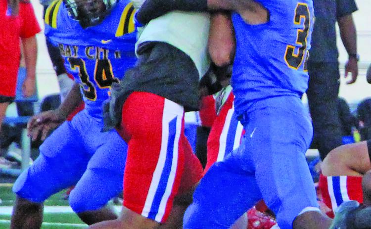 Sentinel Photo/Mike Reddell Blackcat defensive end Jordan O’Neal (33) wraps up a Brazosport Exporter, while freshman defensive tackle Kelon Ellis (34) moves in to help.