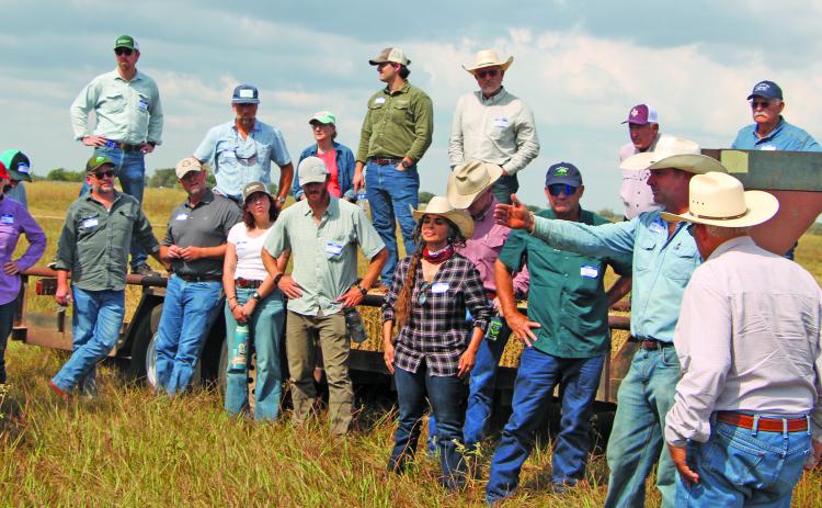 Sentinel Photo/Mike Reddell Adam Sneary, left, points to a pasture at the Sneary Cattle Ranch during a recent field day that covered topics such as different grazing management processes.