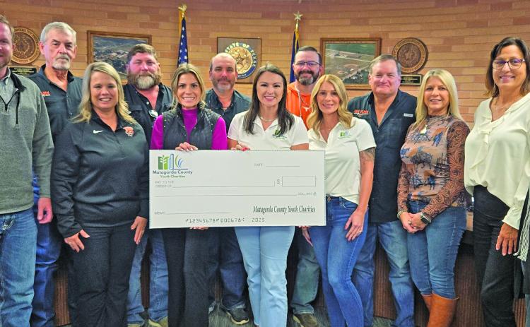 Sentinel Photo/Jessica Shepard Van Vleck ISD trustees join with others to show off the $2,000 donation from Matagorda County Youth Charities.
