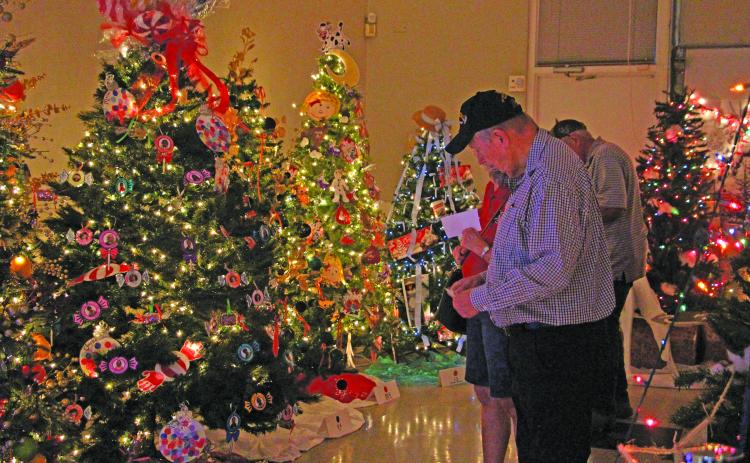 Sentinel Photo/Jessica Shepard People check out the bright and colorful ornaments at the Matagorda County Museum’s Festival of Trees.