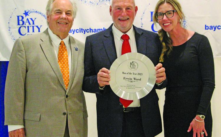 Sentinel Photo/Jessica Shepard Erwin Ward shows off his Man of the Year 2025 Award he received at the annual Bay City Chamber of Commerce and Agriculture Banquet Jan. 15. Outgoing chair John Dickerson and Chair-Elect Savannah Cornelius join Ward in the presentation.