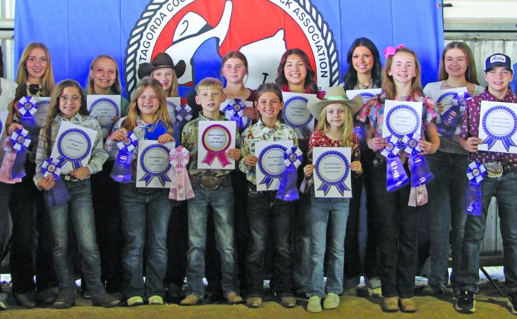 Sentinel photo/Jessica Shepard  Matagorda County Fair and Livestock Association's Home Economics food entry winners received purple rosettes for their win as Grand Champions of their chosen divisions Saturday, Feb. 28. Winners include Raelyn Owen, Ellie Hutto, Abagail Straub, Meredith Jones, Aubree Savage, Olivia Mitchell, Ashley Alford, Drake O’Connell, Abigail Jurek, Ellie Curtner, Jase Alford, Aribella Carson, Jayci Downs, Keagan Gerberman, Taylor Martinez, Savannah Remmy, and Jace Reynolds.