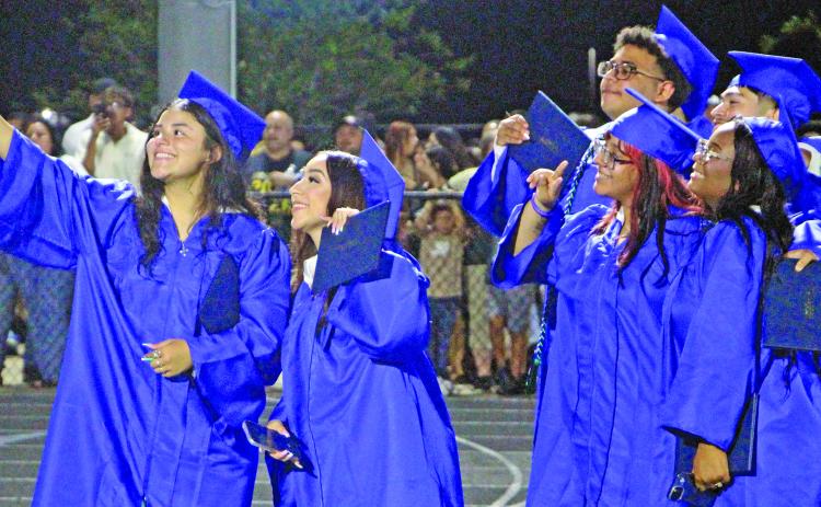 Sentinel Photo/Jessica Shepard New minted Bay City High School graduates get a group selfie at ceremonies Friday, May 22, at Memorial Stadium.