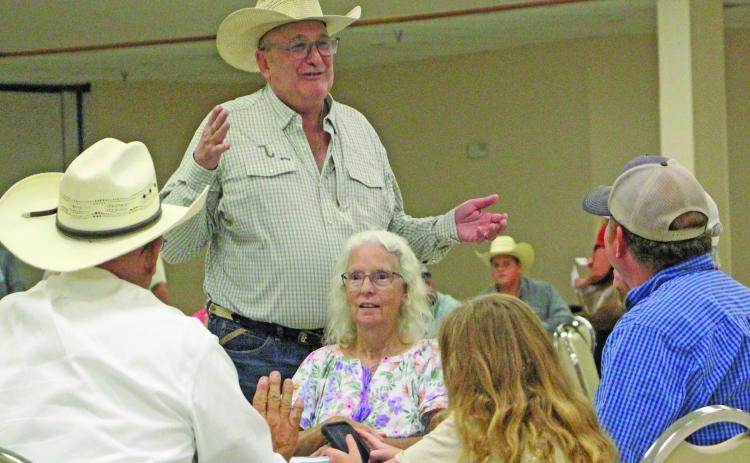 Sentinel Photo/Jessica Shepard Matagorda County Cattlemen's Association member George Harrison, standing, talks with several attendees at the MCCA's "New World Screwworm Seminar" on Thursday, June 25.