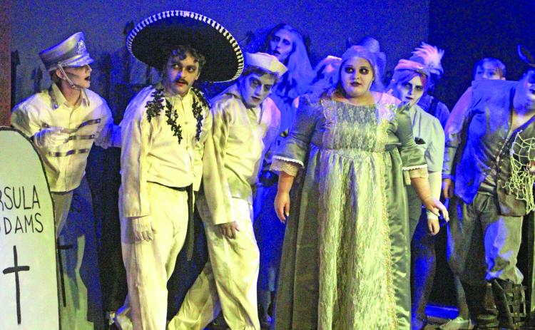 Sentinel Photo/Jessica Shepard Several ghosts of Addams Family members past look on as current members discuss plans for an upcoming dinner event during the production's press night July 29. Over two dozen actors and actresses are part of CAST's "The Addams Family" musical comedy wrapping up this weekend.