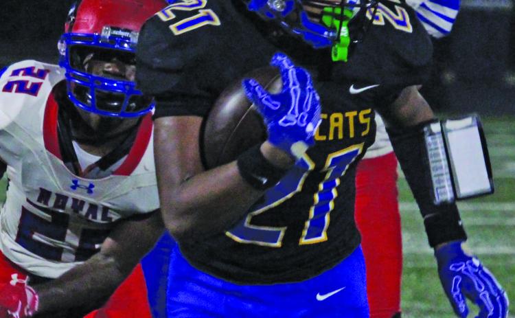Bay City sophomore running back Davieon Agu (21) pulls away from Brookshire Royal defenders during last Friday’s Homecoming game. Sentinel Photo/ Mike Reddell