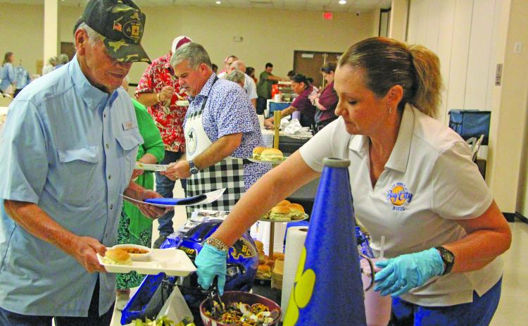 Chris and Melanie Townsend, right, served up a variety of food during the Matagorda County Museum's annual "Gourmet Guys" fundraiser on Saturday, Oct. 3. The Townsends operated one of over a dozen tasting tables with menus centered on the event's "525,600 Minutes: How Do You Measure a Year?"  Sentinel Photo/Jessica Shepard