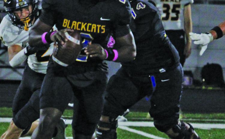 Sentinel Photo/Mike Reddell Bay City quarterback Keimarion Wiggins (2) rolls out to find a receiver against Sealy Friday night.